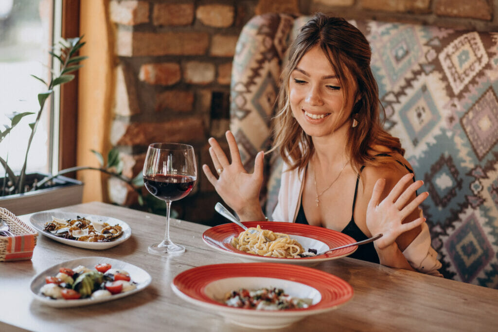 Woman eating pasta in an italian restaurant